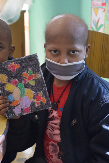 Feeling proud of his colourful shapes with the black background